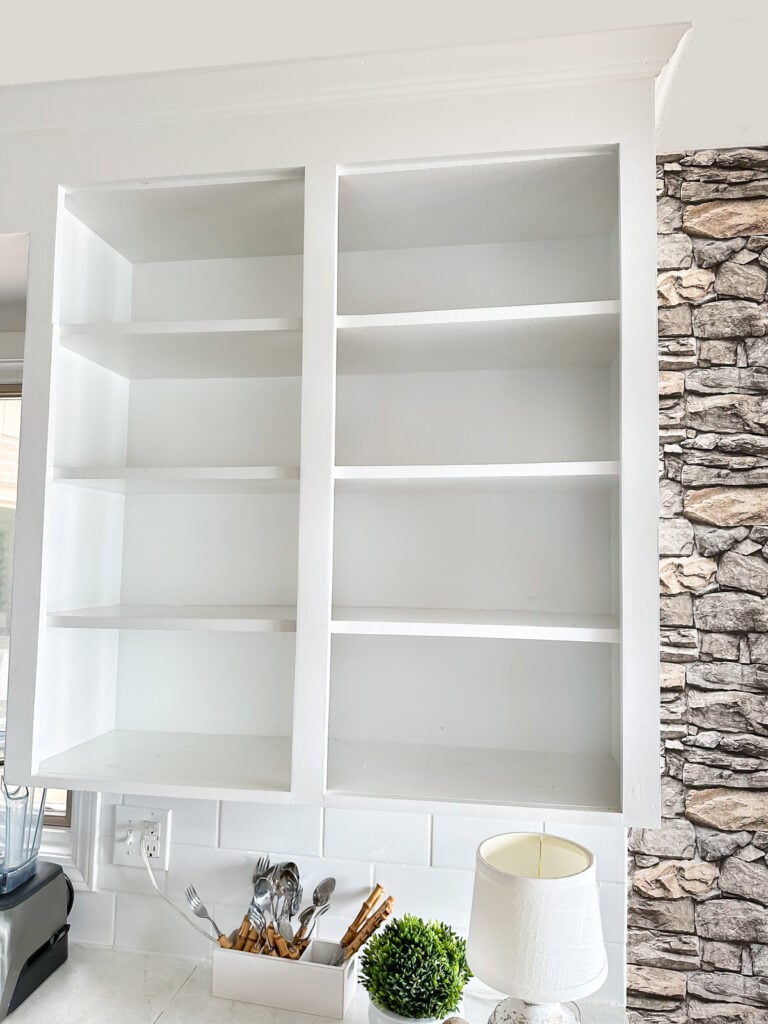 empty open shelves in white kitchen