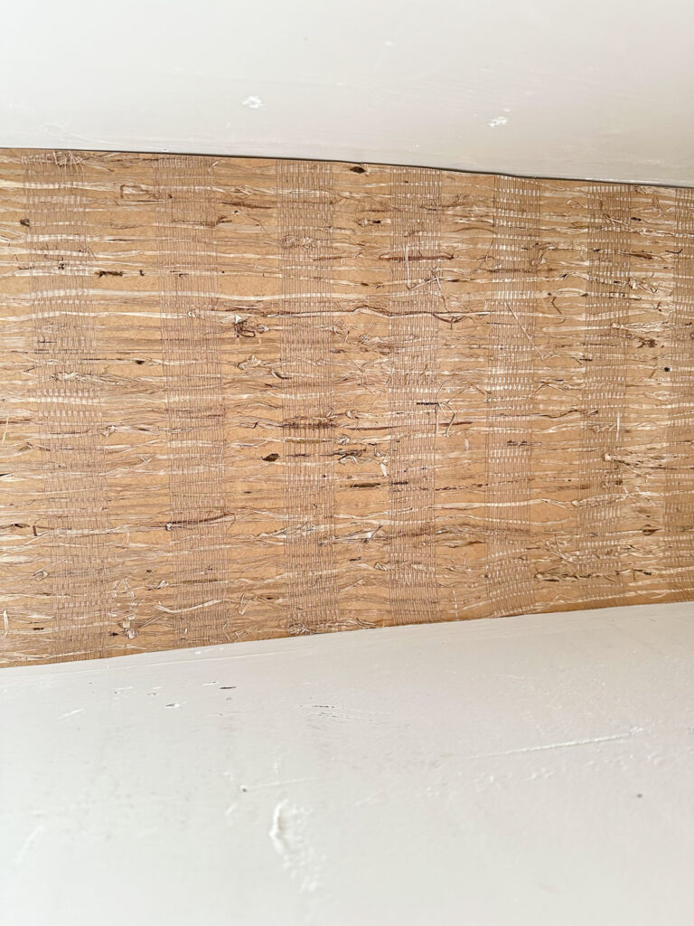 Closeup of wallpaper on the back wall of open kitchen shelving to decorate it for autumn.