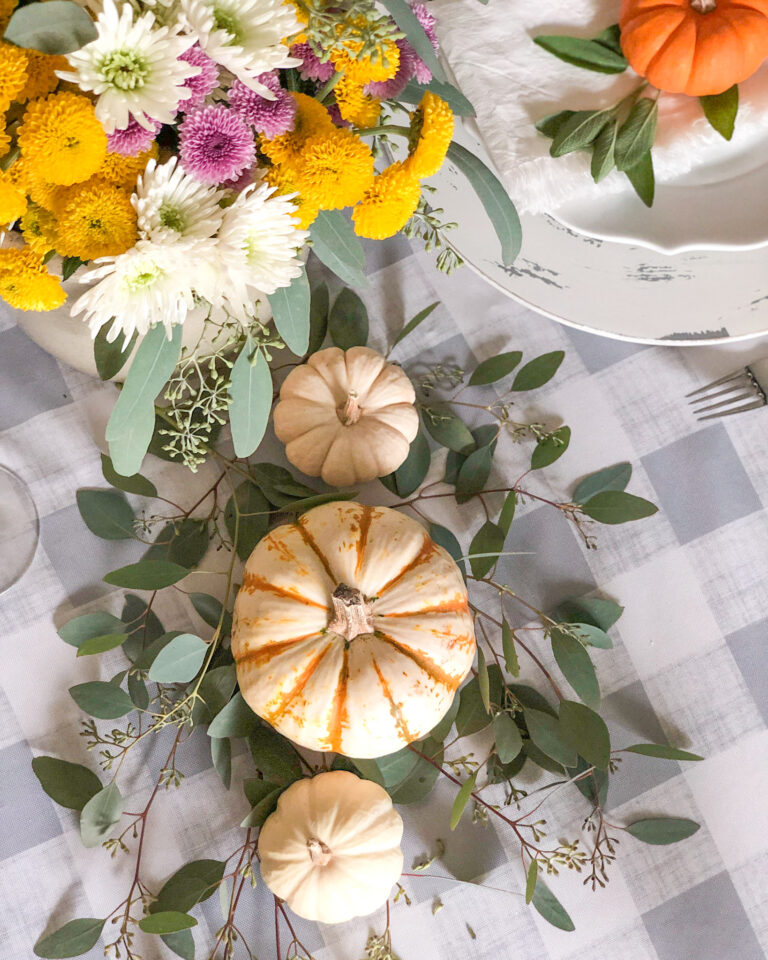 fall table setting with small pumpkins