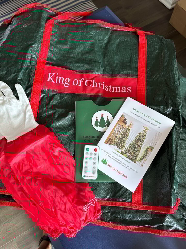King of Christmas Christmas tree storage bag, tree fluffing gloves and remote control for lights.