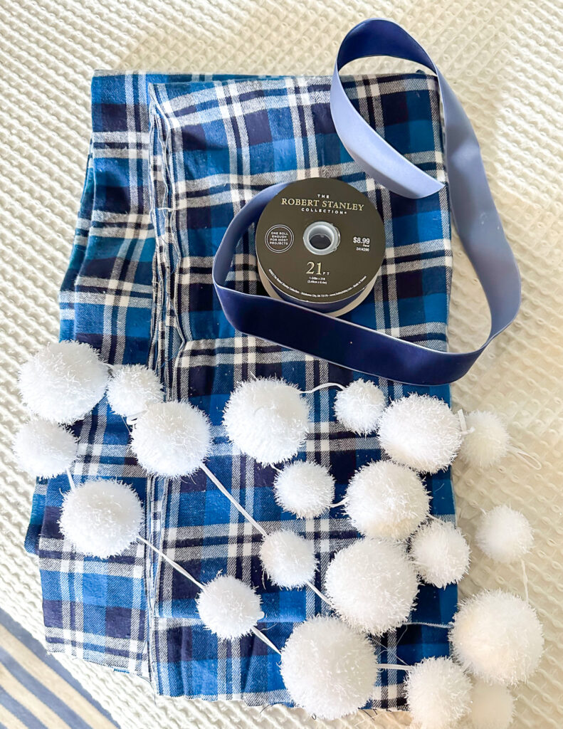 blue and white plaid fabric, blue ribbon and snowball garland.