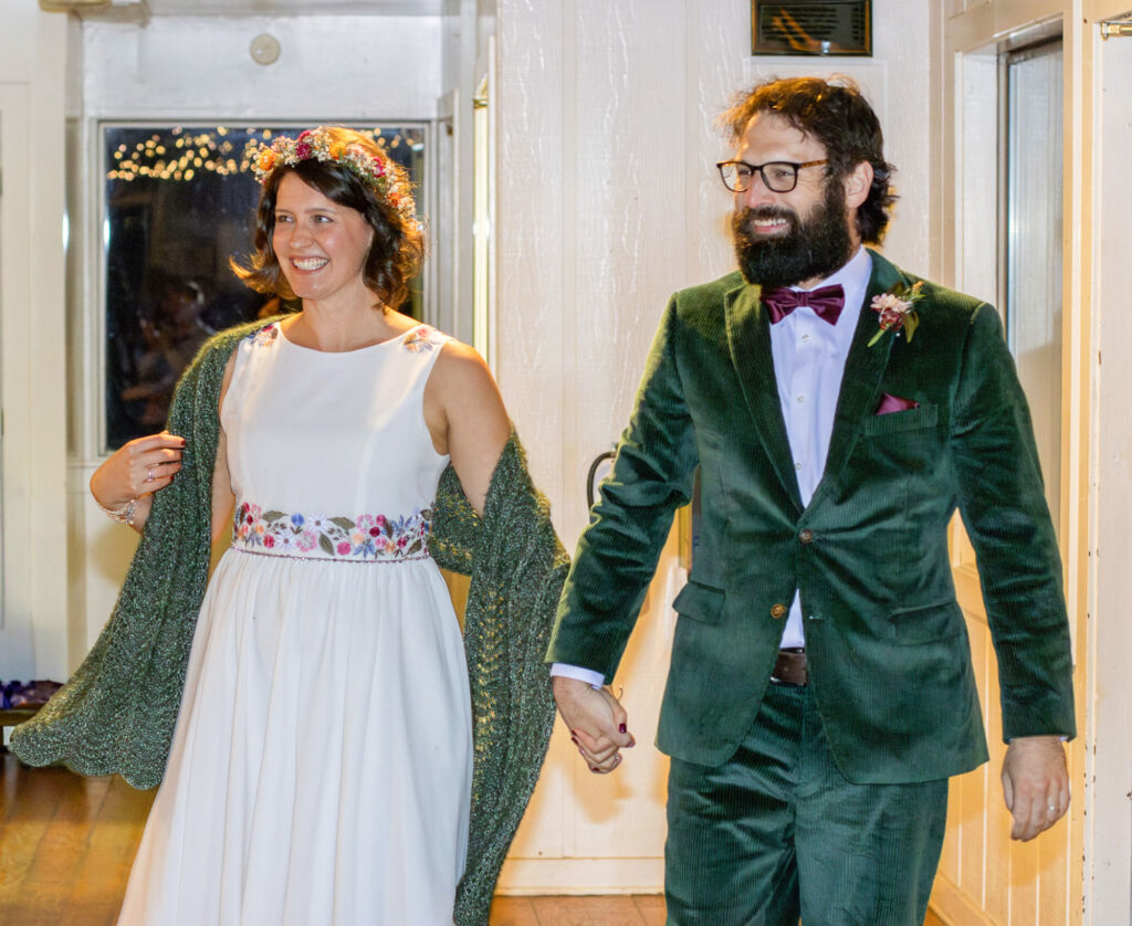Bride and groom entering reception