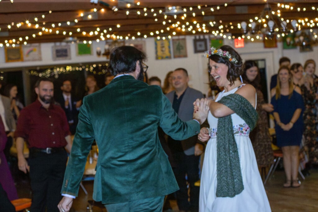 bride and groom dancing under twinkle lights.