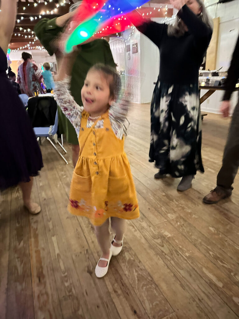 Flower girl dancing with a foam glow stick
