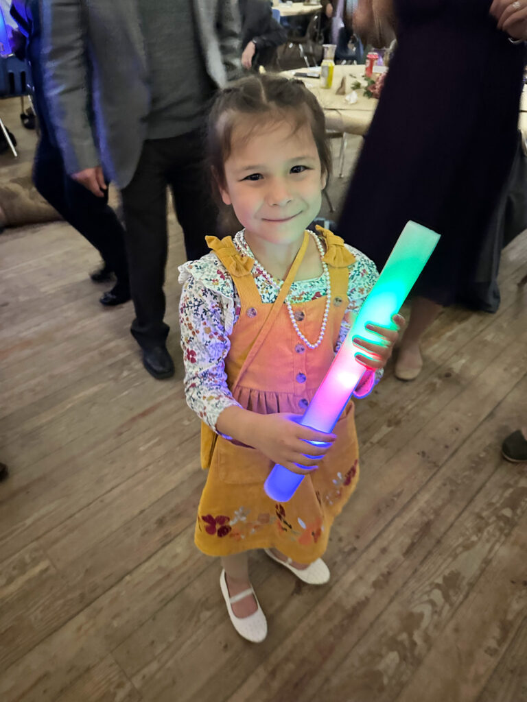 Flower girl dancing with a foam glow stick