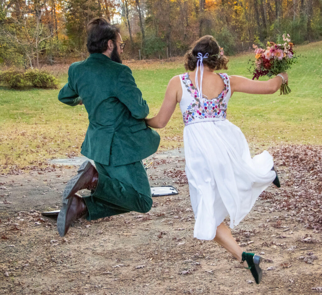 Mandy-and-Matt-jumping after getting married at wedding ceremony.