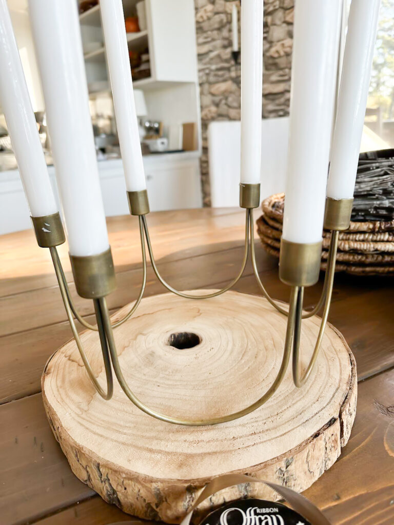 Antique Brass 6 taper candle centerpiece on wood slice on table