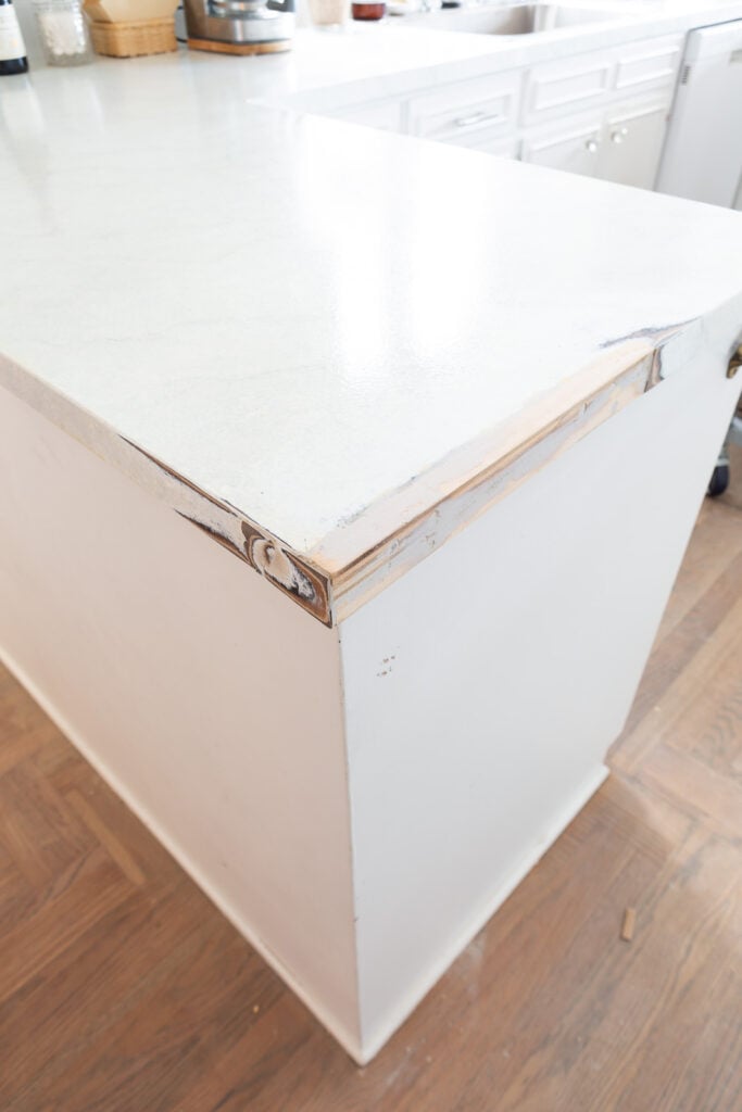 piece of wood added to fill empty space where wood support for upper cabinets were.