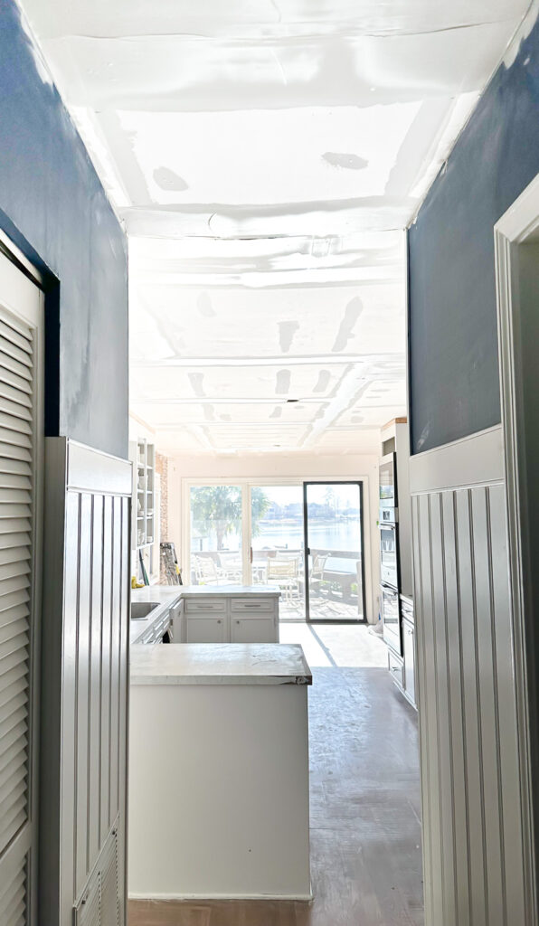 view from hallway of kitchen after popcorn ceiling was removed