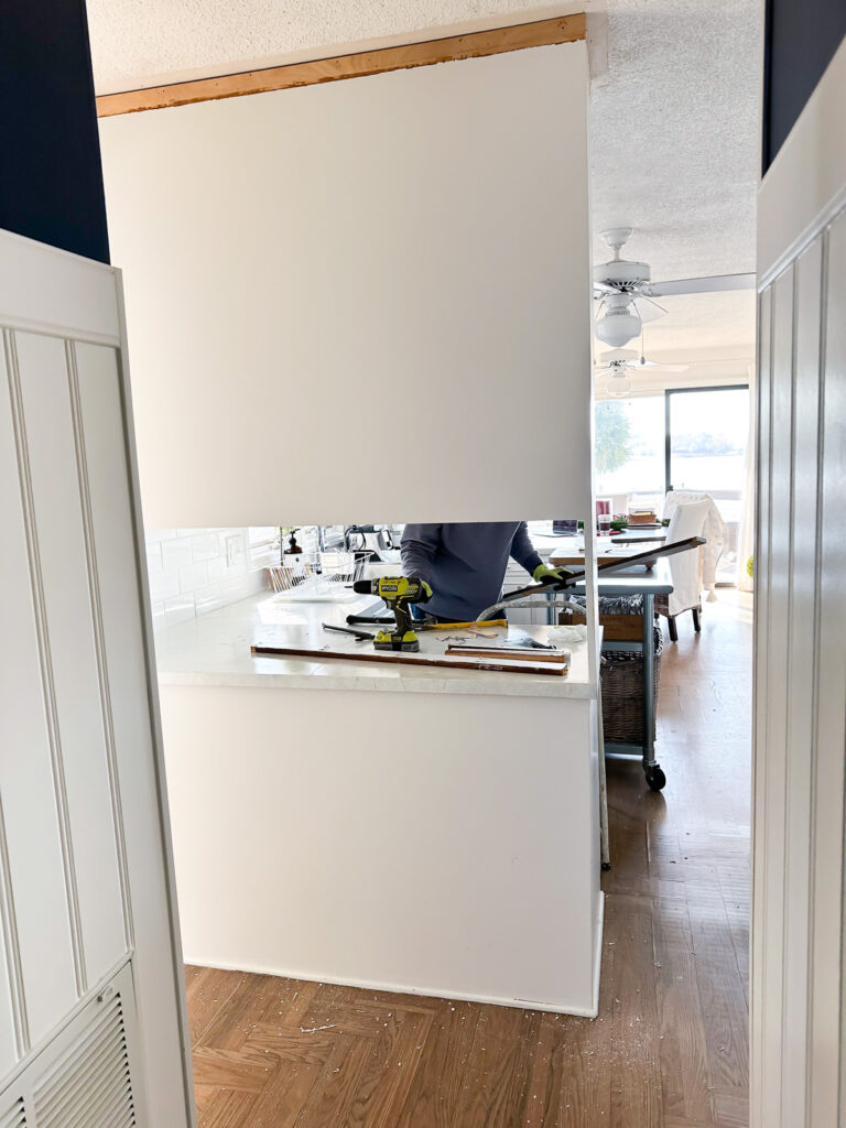 back of section of kitchen cabinets that block the view into the kitchen.