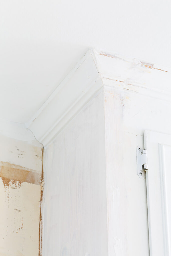 Adding molding back to upper cabinet in kitchen.