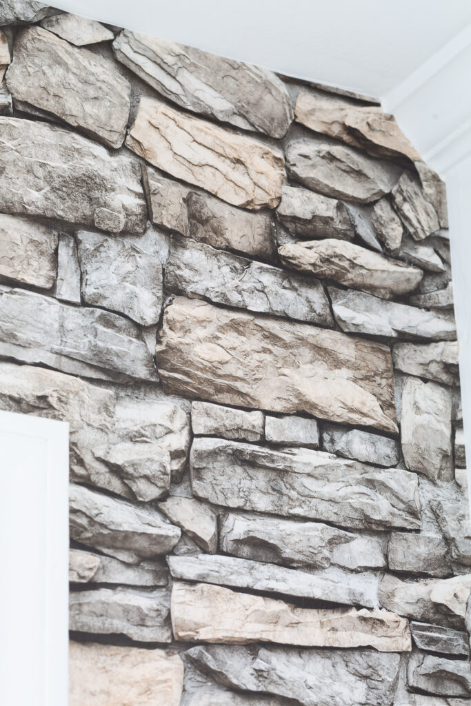 close up of faux stone wallpaper on accent wall in kitchen.