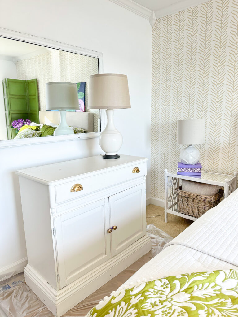White painted sideboard in a bed room after it was swapped from another room in the house.