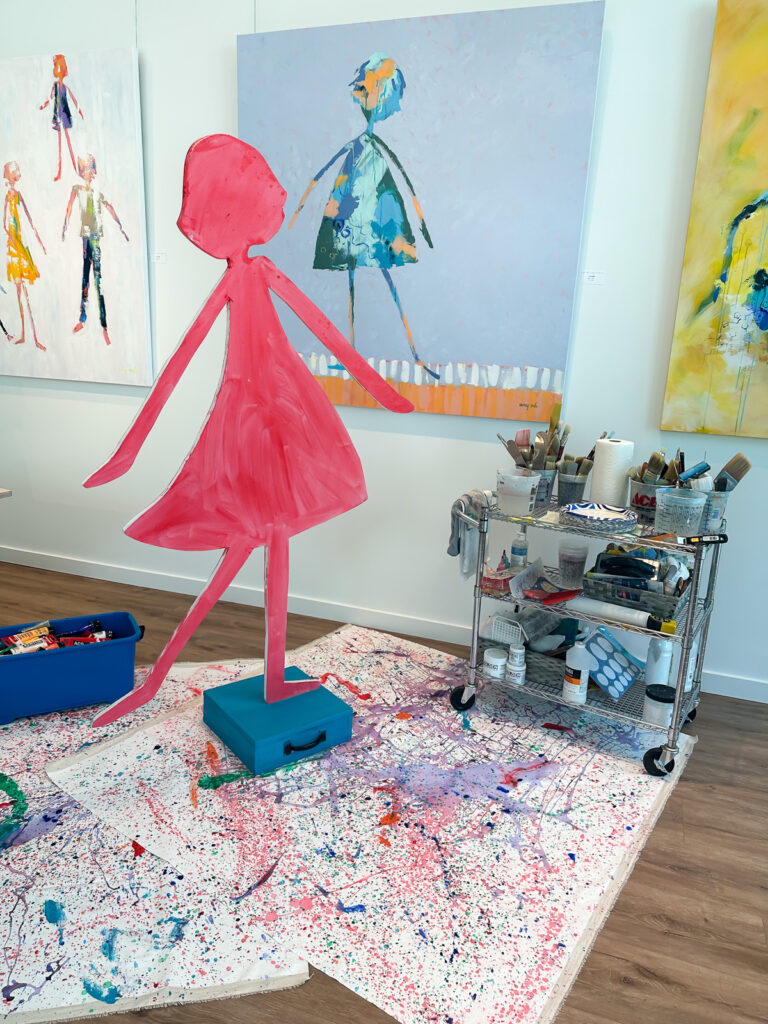painting a wood cutout on a stand to create art for home decor.