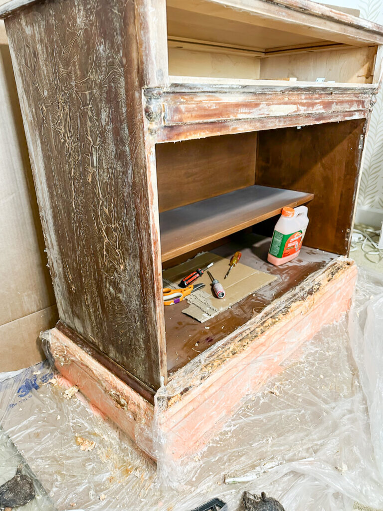 paint stripping a piece of wood furniture