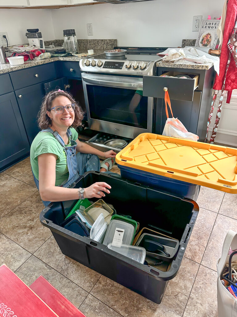 new homeowner getting unpacking kitchen items in a kitchen.