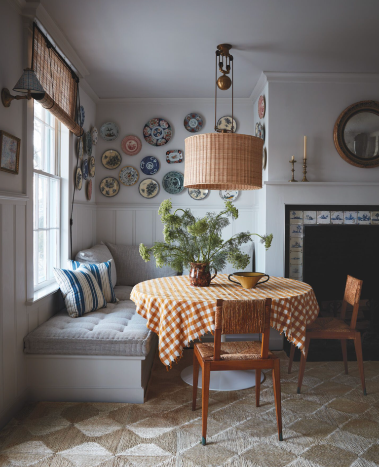 plates decorate a wall above a kitchen banquette