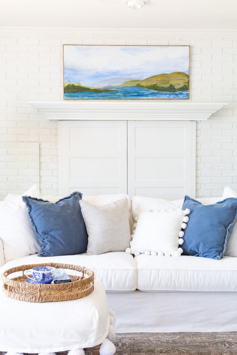 Blue and white living room with custom made wall art by the homeowner