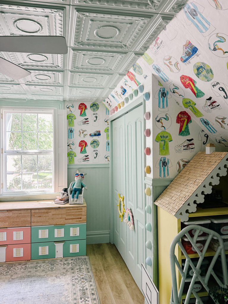 a kids room with the kids artwork made into wallpaper on the walls