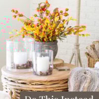Fall flowers and candles on a wicker table. Text overlay says - Don't decorate for fall, do this instead.