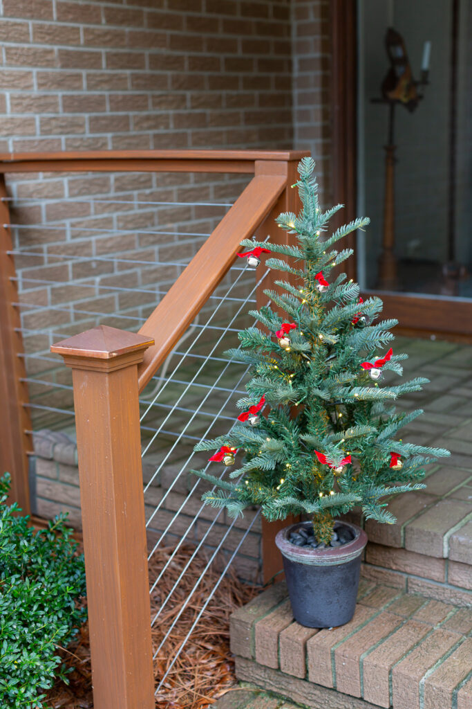 3 ft Christmas tree on front steps of a home