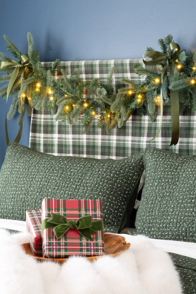 King of Christmas garland draped over bed headboard.
