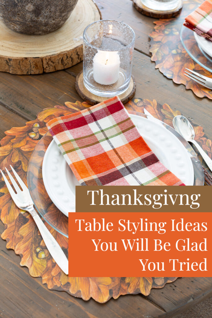 A Thanksgiving table setting on a wood plank table. Text overlay says Thanksgiving table styling ideas you will be glad you tried.