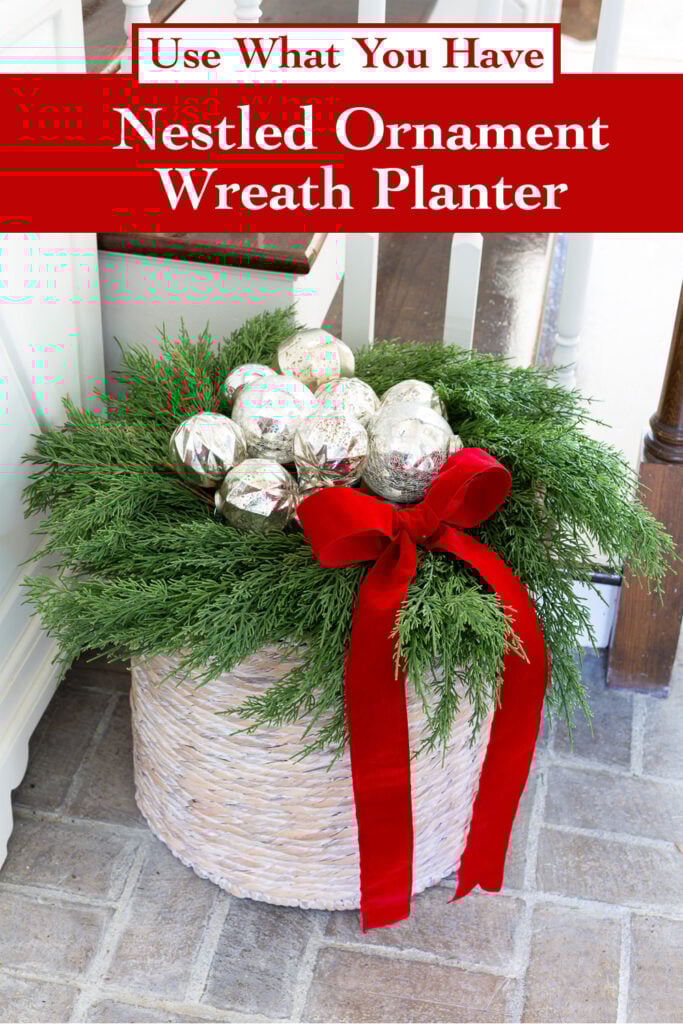 nestled Christmas ornaments on a wreath and basket planter.