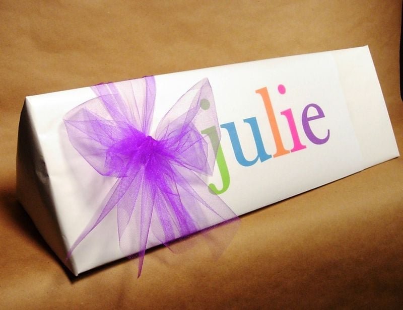 Gift wrap idea. White craft paper with computer printed name using a different color for each letter in the name.