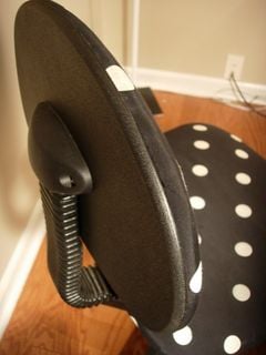 Close up of the back of an office chair seat.