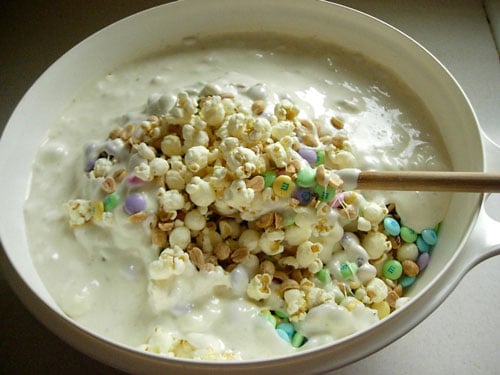 How to make Popcorn-cake-recipe shown step by step. Mixing all the melted ingredients together.