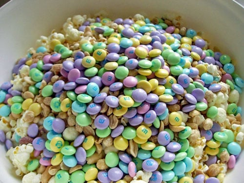 A big bowl filled with Popcorn-Cake-ingredients mixed-with-M&Ms